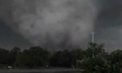The funnel of a tornado on the outskirts of a University of Alabama parking lot: Hundreds have died in a series of devastating tornadoes.