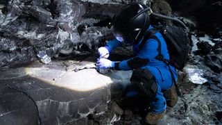 Dr. Michaela Musilova collects samples for astrobiology research in a lava tube, as part of a collaboration with NASA Goddard.
