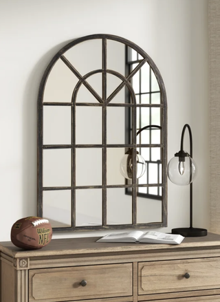 Arched accent mirror resembling a window from Wayfair.