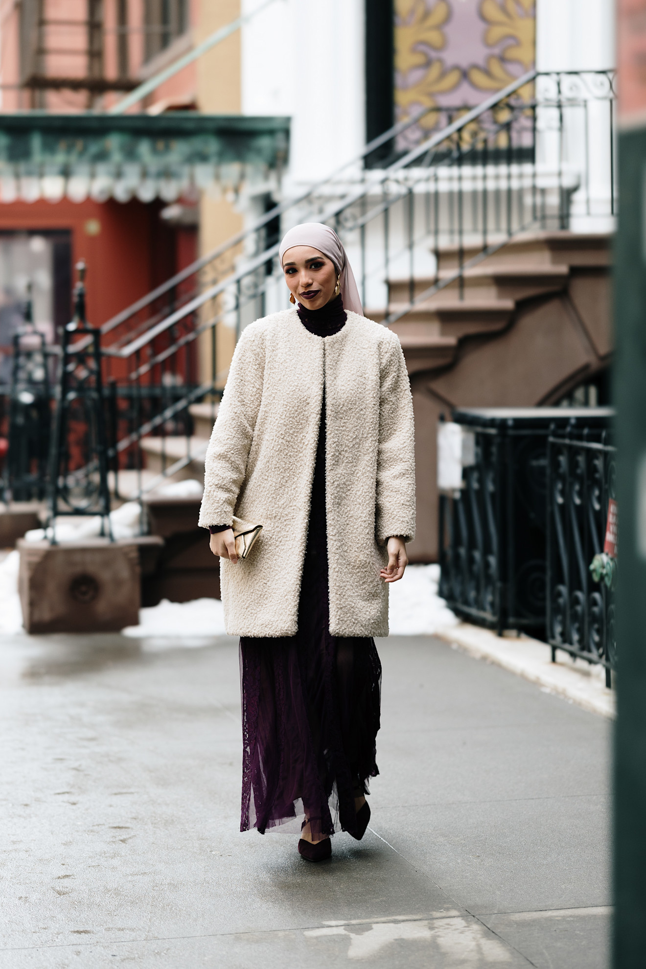 woman wearing collarless coat, dress, and heels