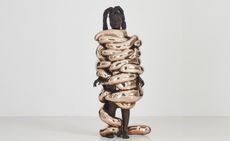 Artist Zanele Muholi wrapped in bronze tubing