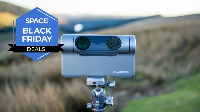 A Dwarflab Dwarf 3 smart telescope on a tripod in a field. 