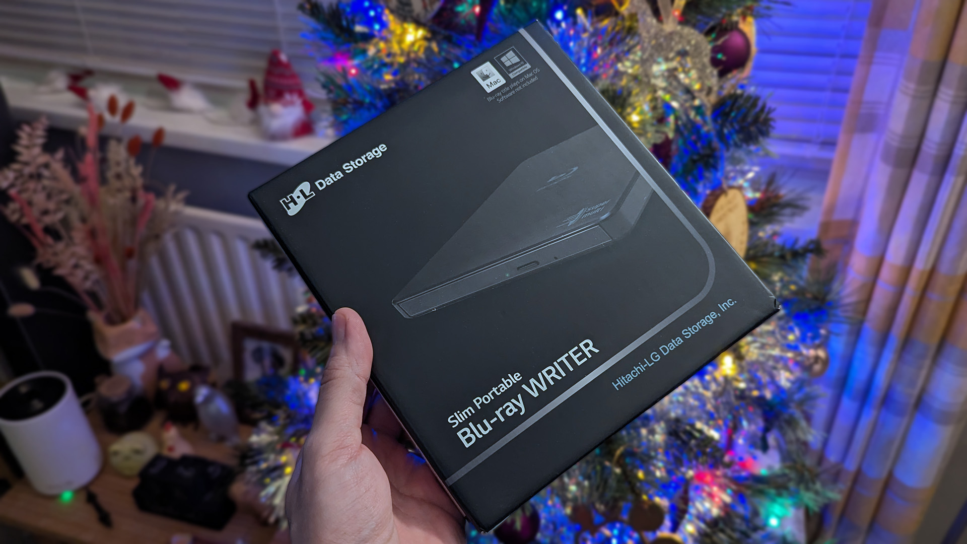 Hitachi-LG BP55 external Blu-ray writer in front of a Christmas tree