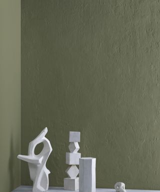 dark green wall with white ornaments in foreground