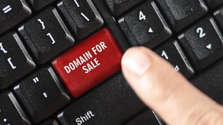 "Domaine à vendre" écrit sur un bouton de clavier rouge