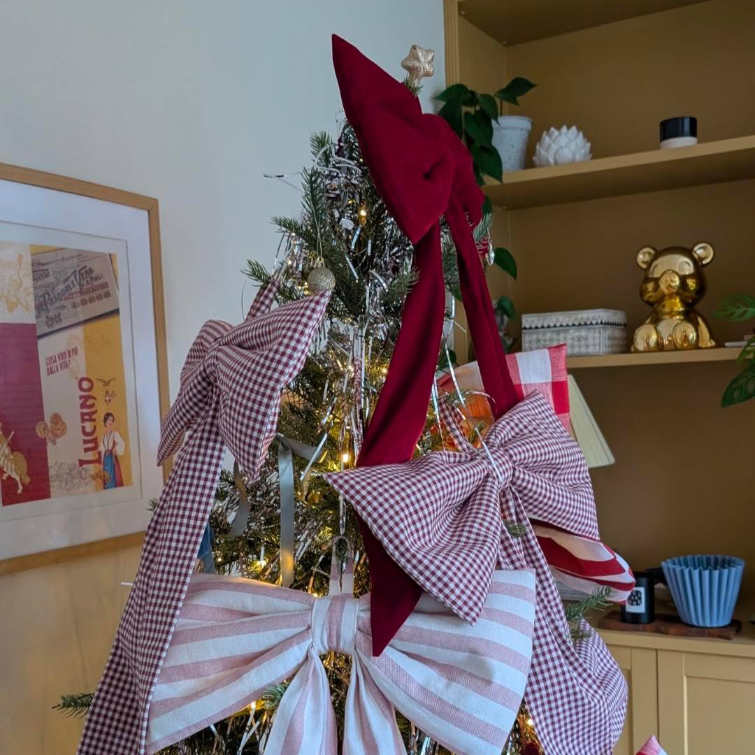 christmas tree covered in large red and white bows
