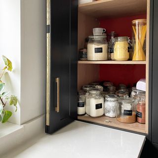 Cupboard with shelves used to store dried food stuff in jars
