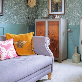 colourful living room with wallpaper and purple sofa