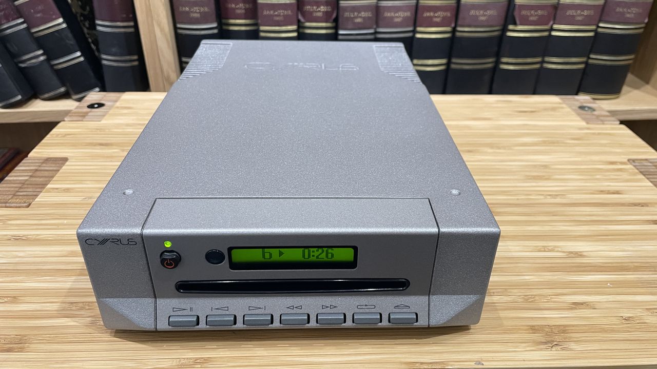 Cyrus CDi player on wooden rack with magazines in background