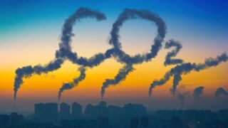 Industrial chimney smoke spelling out "CO2"