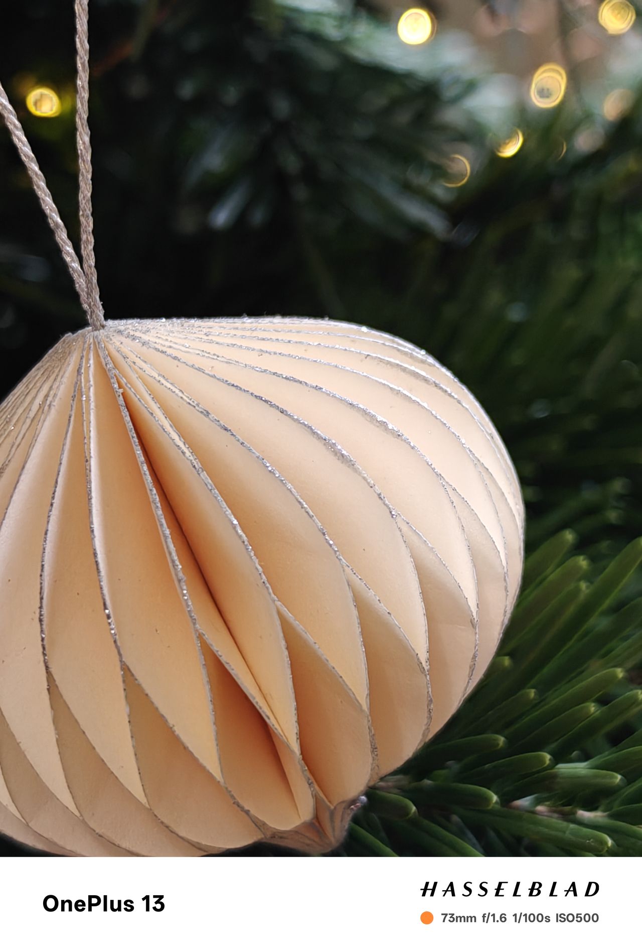 Close-up of a paper decoration hanging on a Christmas tree