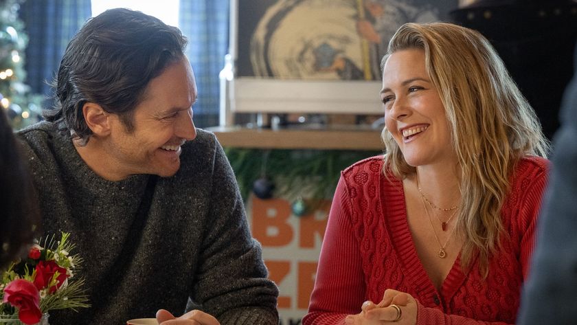 Alicia Silverstone and Oliver Hudson smile and laugh at each other 