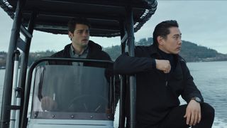 Owen and Jang drive a boat to meet with the Yakuza in The Recruit season 2