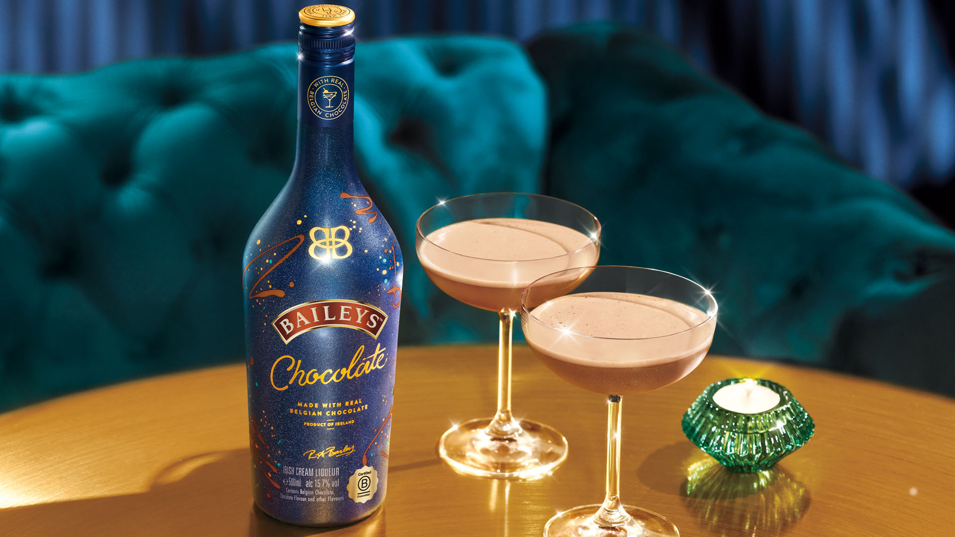 Baileys Chocolate Irish Cream Liqueur, on a table with candles and cocktails