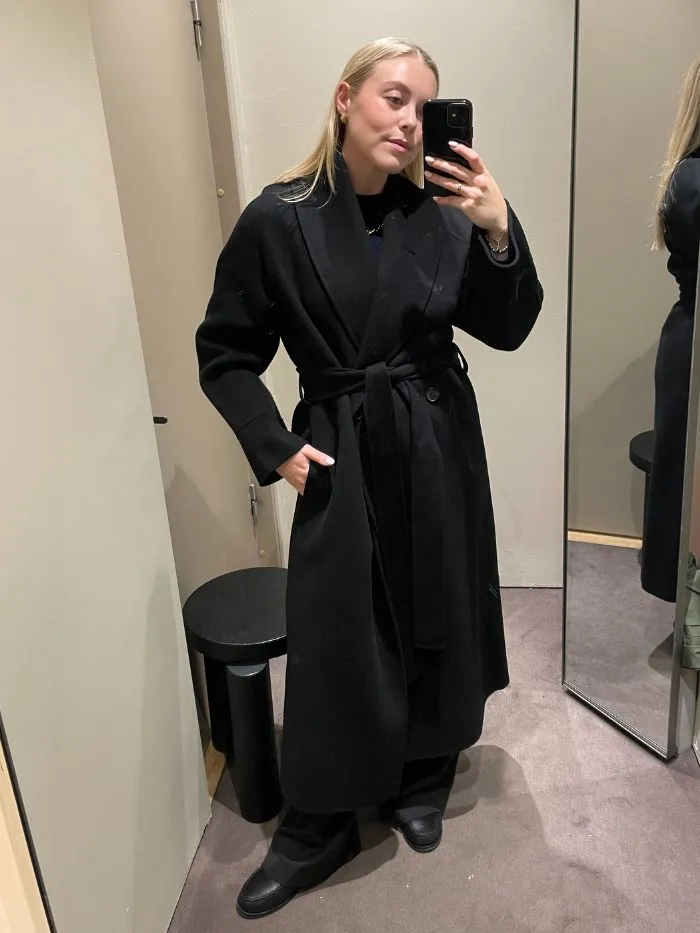 Shopping Editor Florrie wearing COS black wool coat