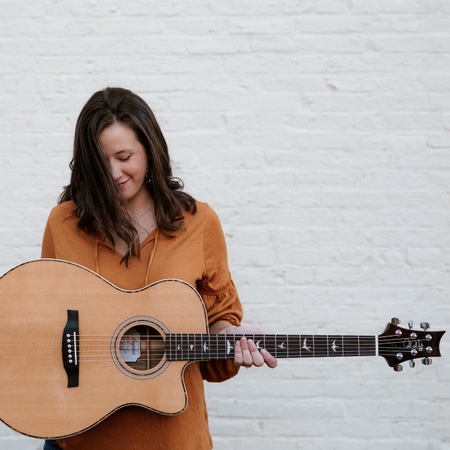 woman playing prs guitar