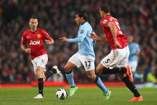 Carlos Tevez in action for Manchester City against former club Manchester United in 2013.
