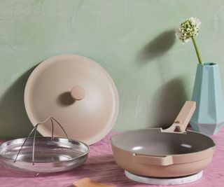 Always Pan 2.0 in almond on a pink counter against a sage green wall.