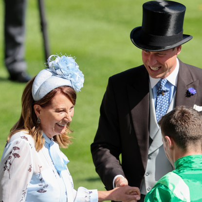 Carole Middleton holds hands with Prince William, Prince of Wales as they attend day two of Royal Ascot 2024 at Ascot Racecourse on June 19, 2024 in Ascot, England.