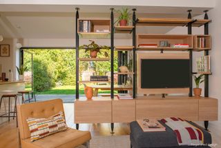 living room with partition wall and TV unit