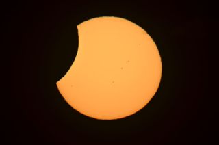 James Tse, from Christchurch, New Zealand, caught a glimpse of the partial solar eclipse on Nov. 25, 2011.