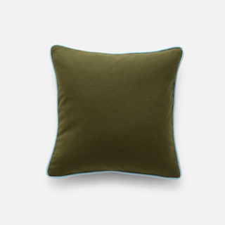 green throw pillow with blue piping