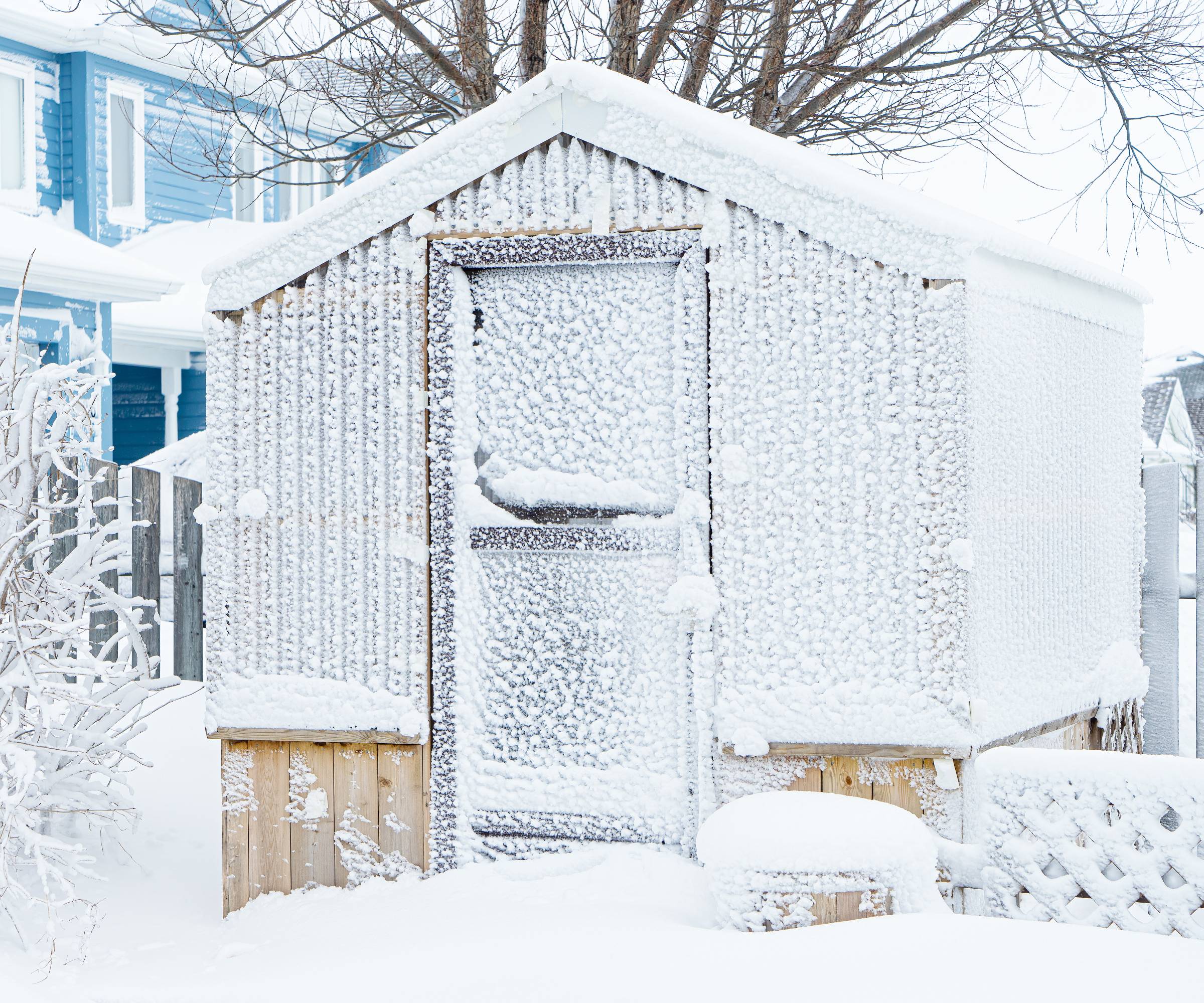 Glass greenhouse coated in snow