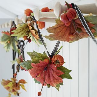 leaf garland with ribbon and berries with chinese lantern seed pods