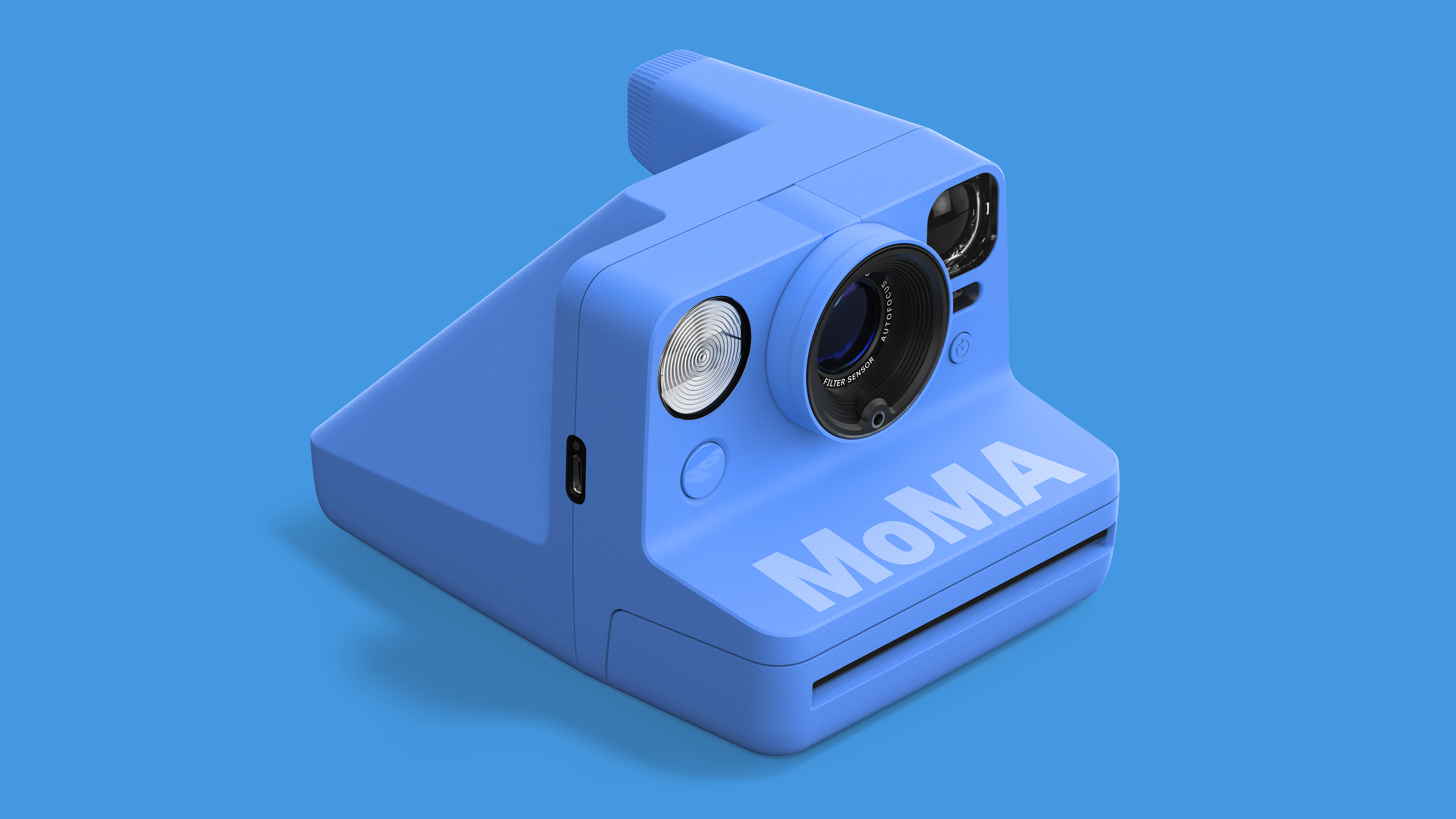 Polaroid Now Instant Camera Generation 3 - MoMa Edition camera against a blue background