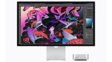 The Apple Mac Mini with M6 chip pictured against a white background with a desktop monitor featuring Adobe Photoshop.