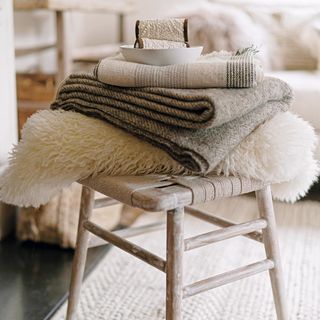 woolly sweaters and blanket on table