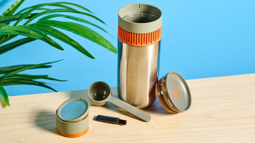 Wacaco Pipamoka portable coffee maker in front of a blue background.