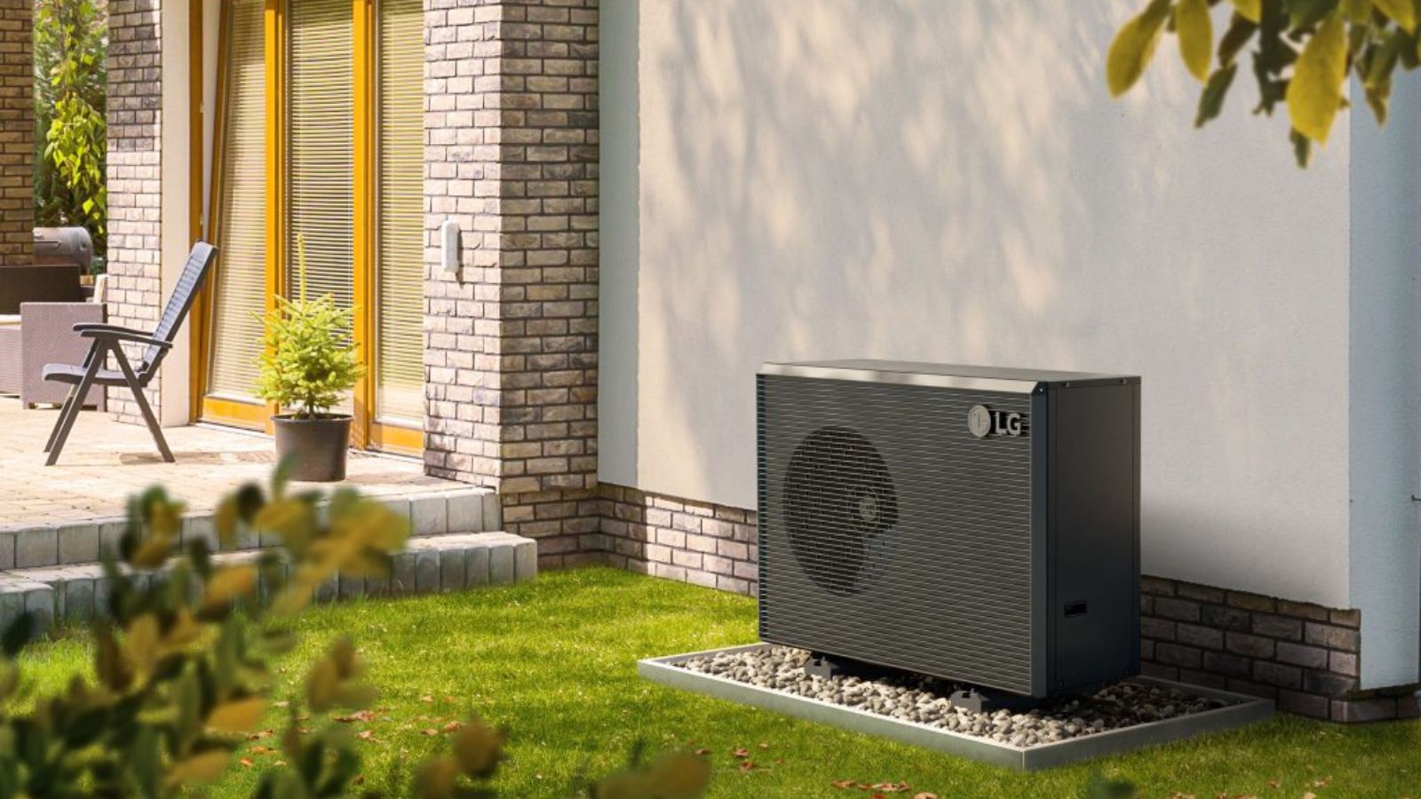 A black outdoor heat pump positioned against a wall