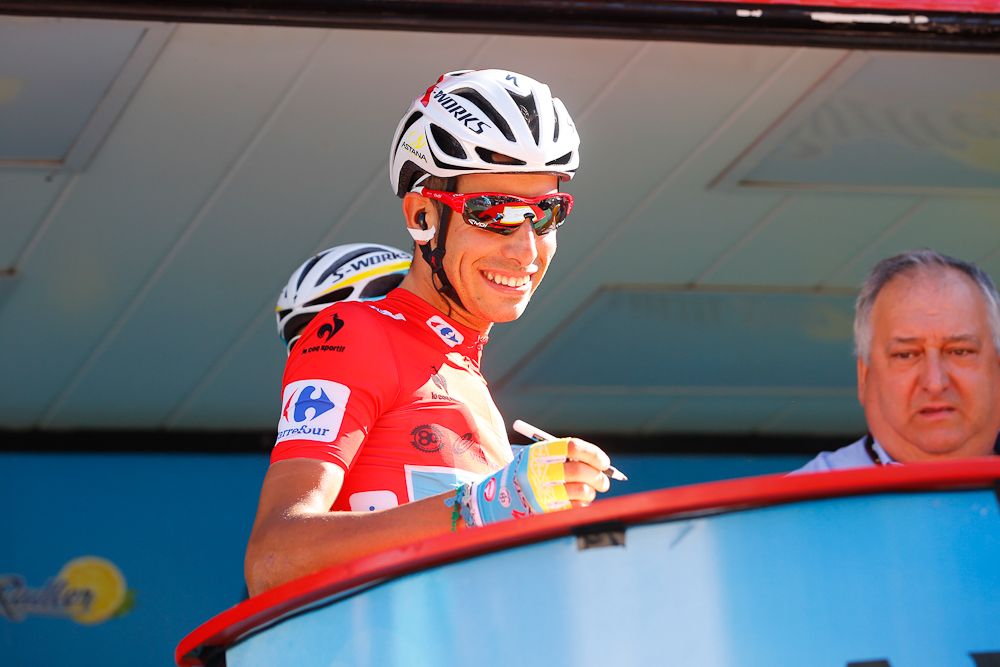 Fabio Aru signs in at the start of the Vuelta's final stage.