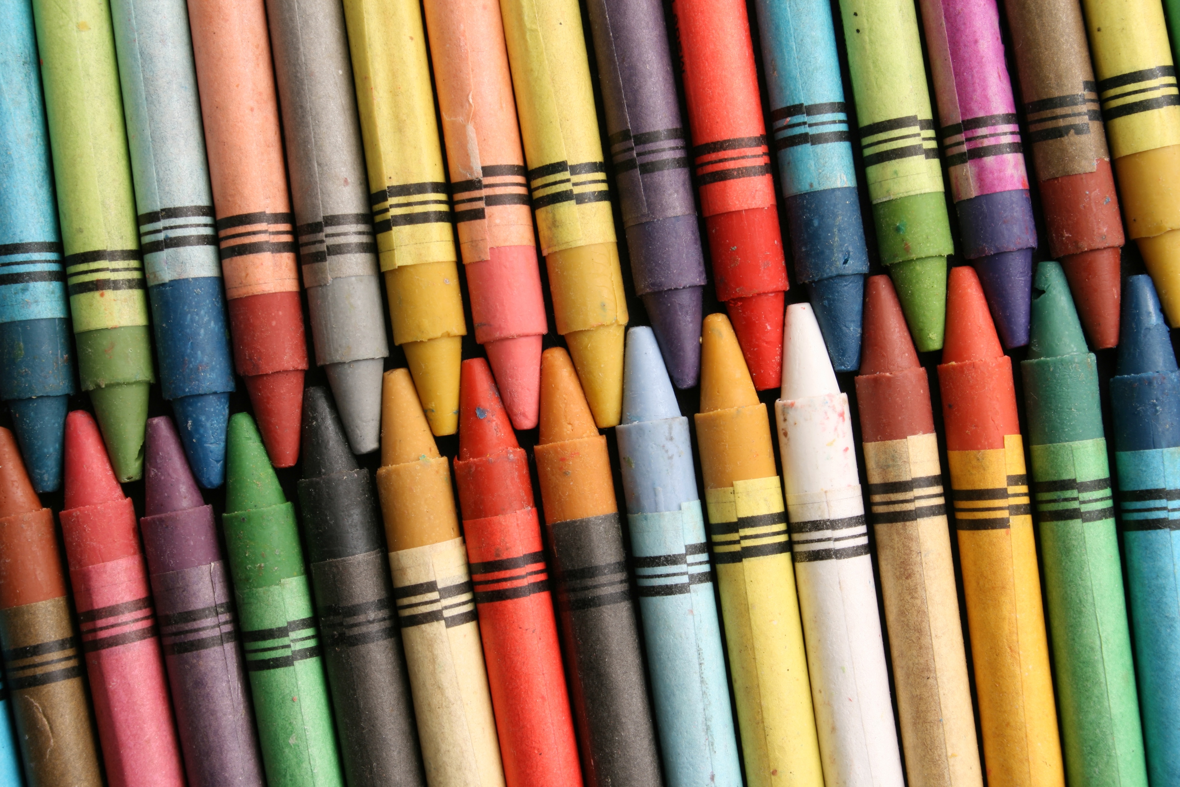 Two rows of brightly-coloured crayons