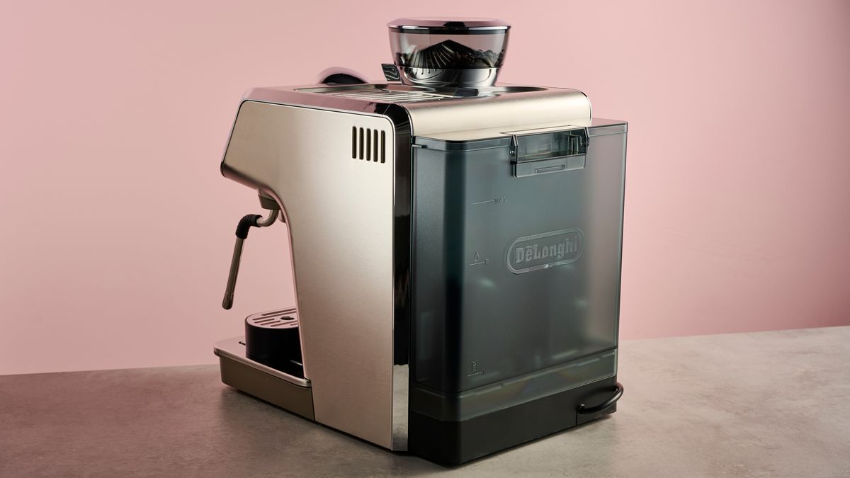 A view of the back of the Delonghi Specialista Arte Evo which sits on a stone-effect surface in front of a pink backdrop.