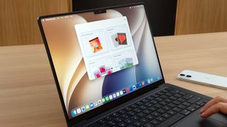 A person using iPhone Mirroring on a MacBook Pro running macOS 27 Golden Gate.