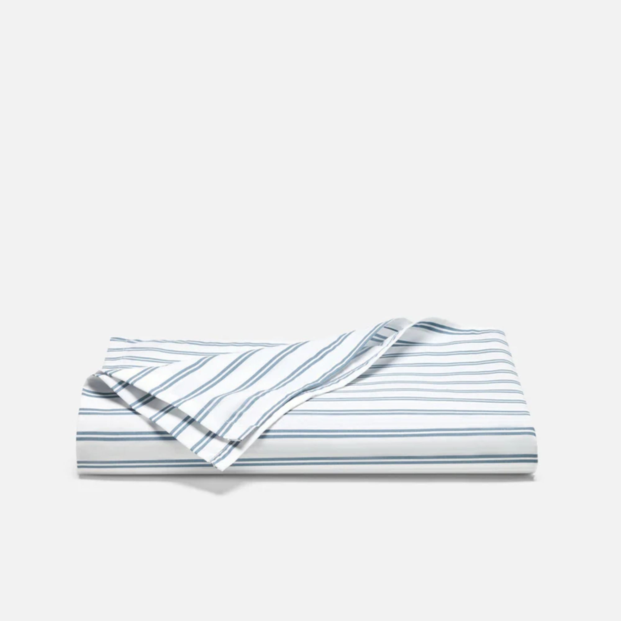 A folded Brooklinen striped white and blue flat sheet