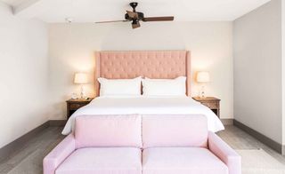 the sun drenched rooms take on an airier vibe with bare walls, ceilings fans and pale pink