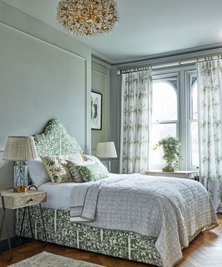 An example of bedroom ceiling light ideas in ornate glass, in a green and white botanical scheme.