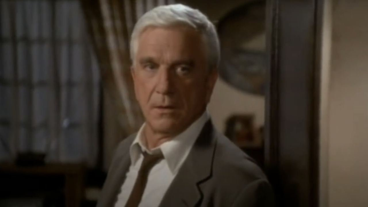 Leslie Nielsen as Frank Drebin in The Naked Gun: From the Files of Police Squad!