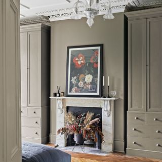 Bedroom with matching large wardrobes on either side of an ornate fireplace
