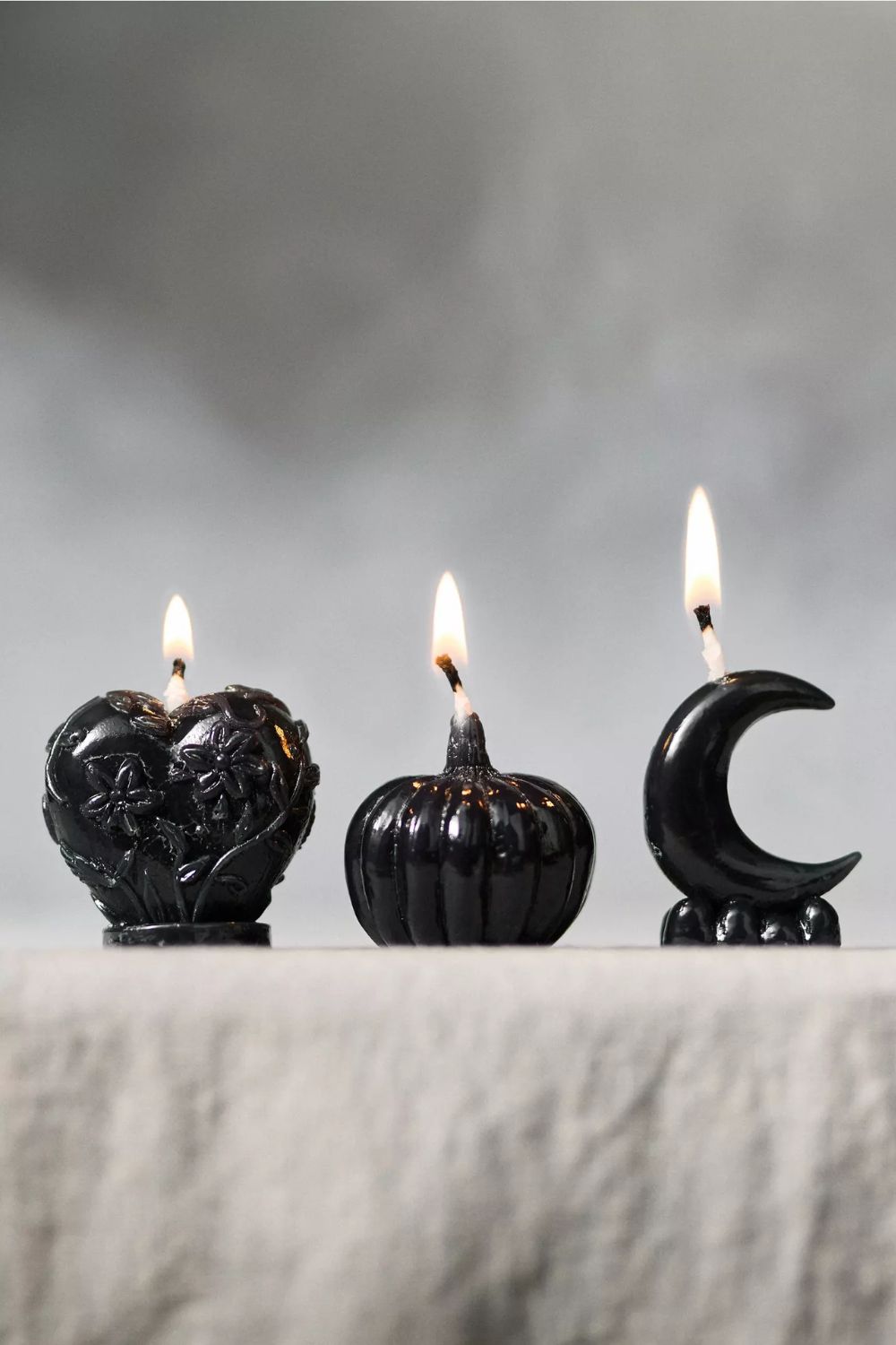 Mini black candles in the shape of a heart, pumpkin and crescent moon