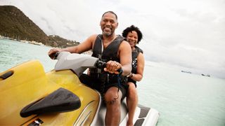 Man and woman on jet ski in the ocean