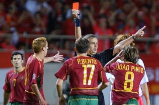 Portugal players protest to the referee as Joao Pinto is sent off against South Korea at the 2002 World Cup.