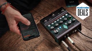 A Kemper Profiler Player amp modeller with a man holding a smartphone