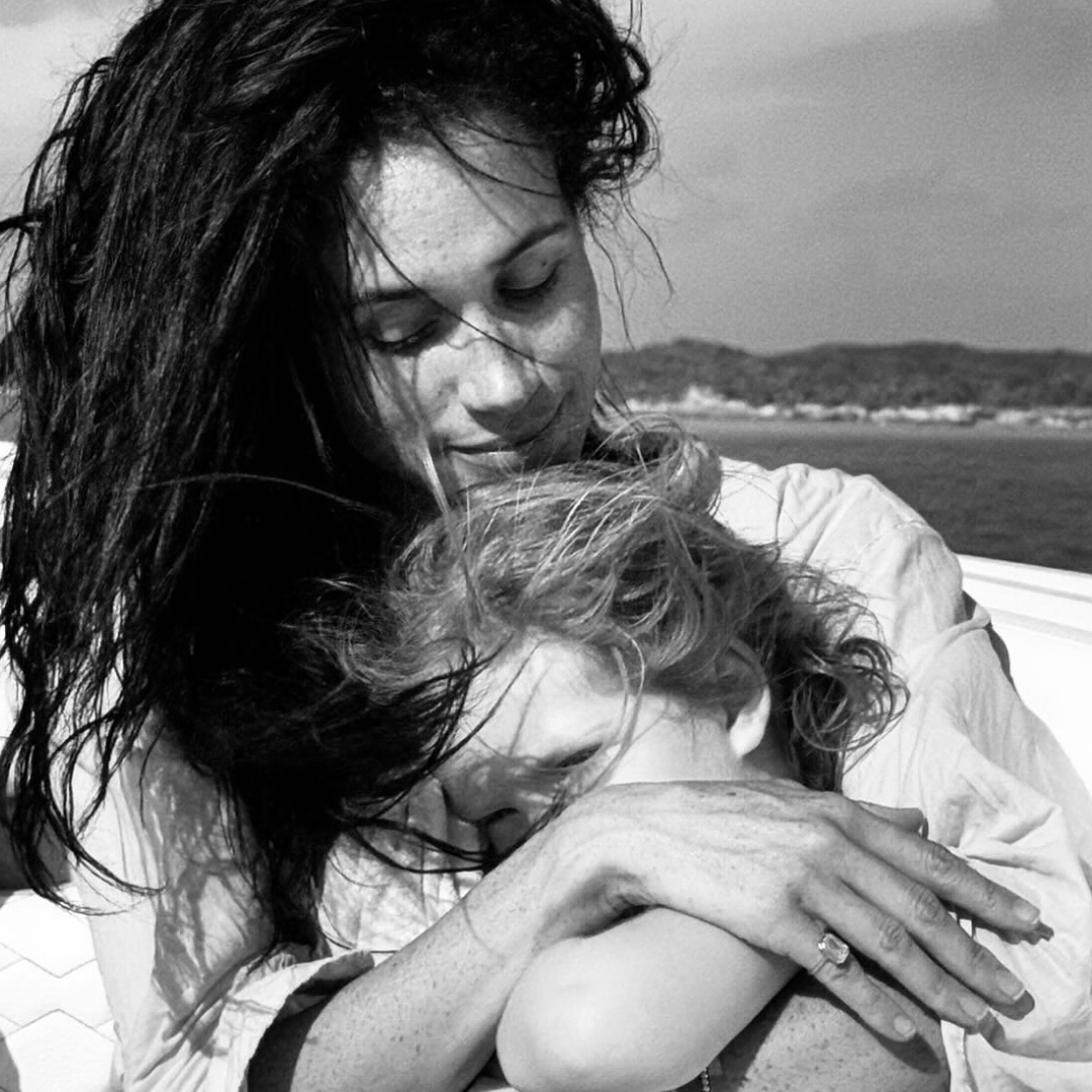 Meghan Markle holding Princess Lilibet on a boat