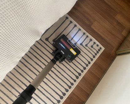 Shark Stratos Anti Hair Wrap Plus Pet Pro vacuuming short pile rug in bedroom