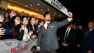 Henry Cavill takes a selfie with fans at the premiere for Enola Holmes 2 in NYC on Oct. 27