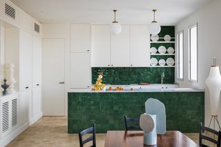 A kitchen with zellige tiles on the island